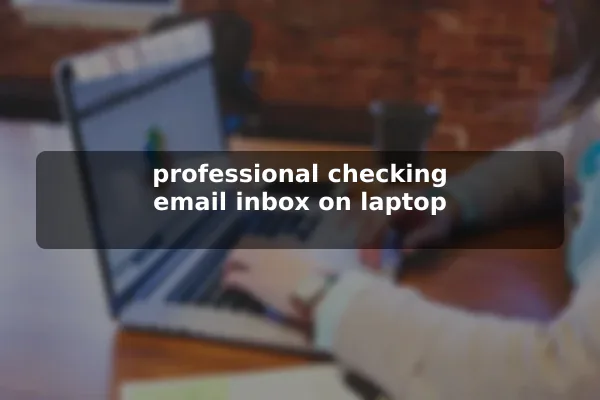 professional checking email inbox on laptop